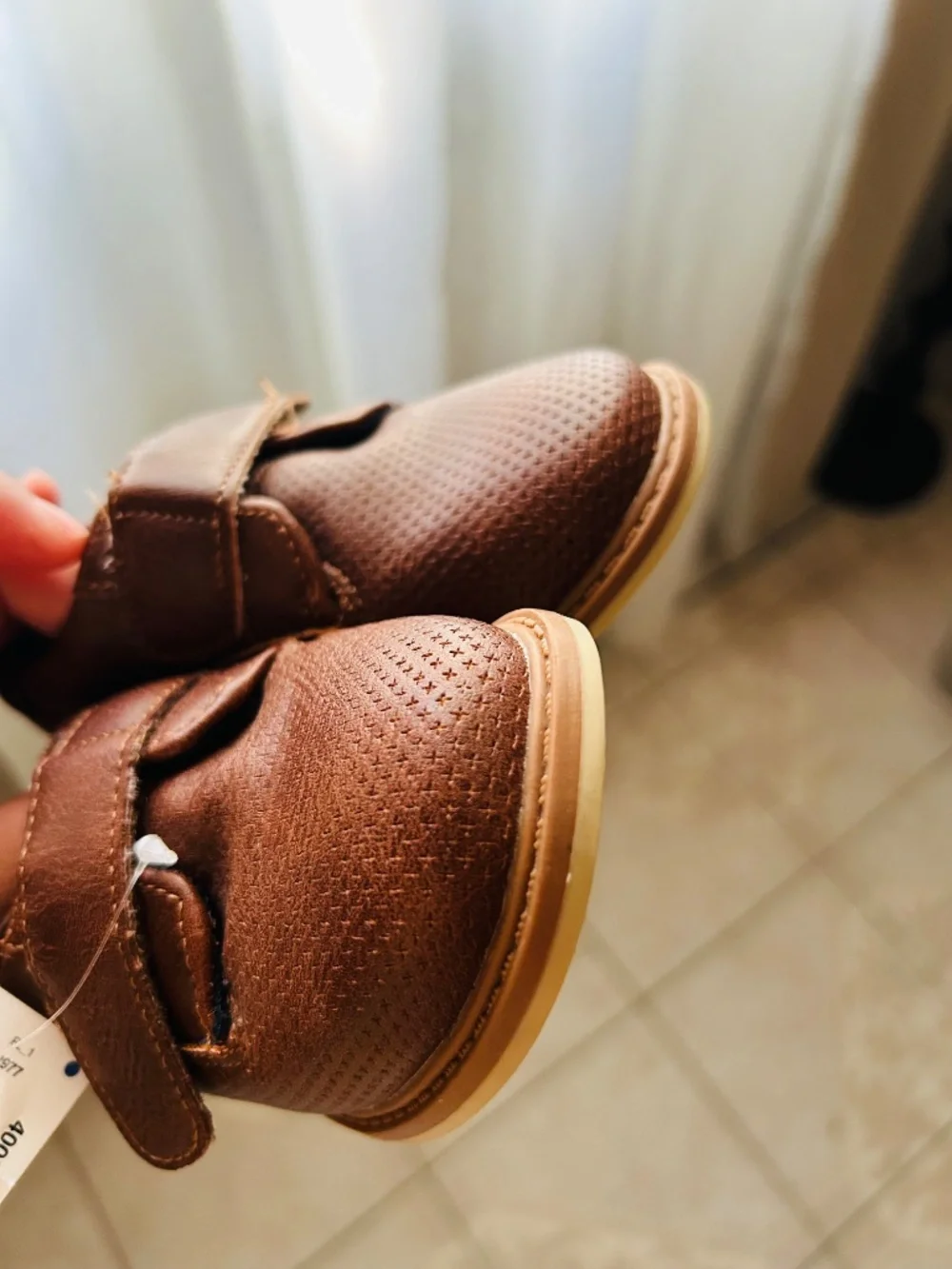 Brown London Underground boys' casual dress shoes feature a strap closure.